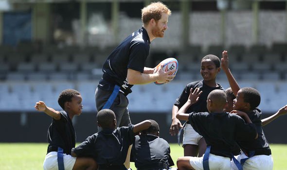 Prince Harry news: The Duke playing rugby with South African children Prince Harry news: The Duke playing rugby with South African children