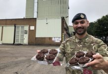Being a Reservist is the best of both worlds – Case study RAF Reservist Danny Railton smiling with two trays of muffins in his hands.