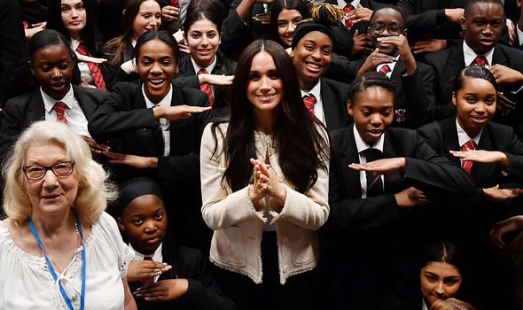 Meghan on International Women's Day in March, with a London school Meghan on International Women's Day in March, with a London school