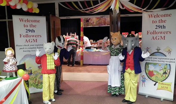 A life-sized Rupert Bear and his chums wave A life-sized Rupert Bear and his chums wave