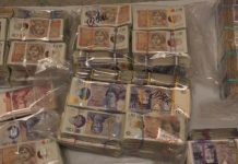 Two charged after cash stuffed into suitcases seized at Heathrow airport