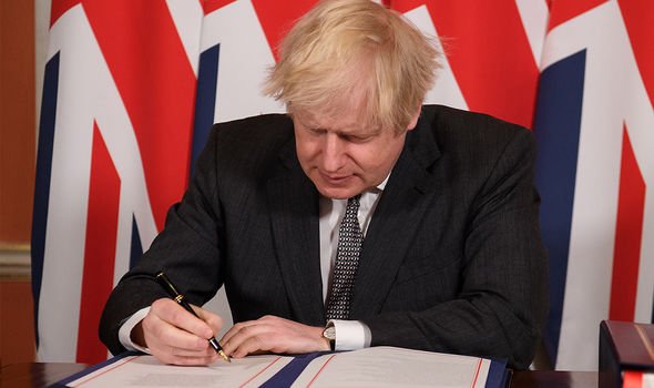 Prime Minister Boris Johnson signing the Brexit trade deal with the EU