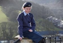Aspiring pilot Mya among youngsters joining the cadets during lockdown – Case study Air Cadet Mya Larder pictured wearing her uniform sitting on a wall smiling directly at the camera.
