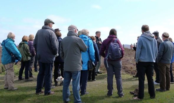 Scotland: People gather during a tour of the stones Scotland: People gather during a tour of the stones