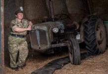 Reservist Tracy Llewellyn combines being a military musician, mum and farmer Reservist Tracy Llewellyn standing next to a tractor dressed in full service uniform.